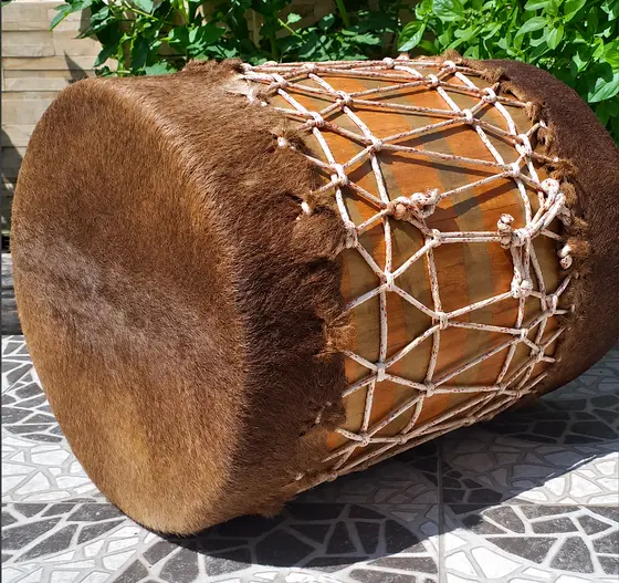 Tambor de madeira com couro peludo e cordoaria trançada